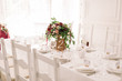 © Olga - Wedding table decoration with the red and pink flowers on the white cloth