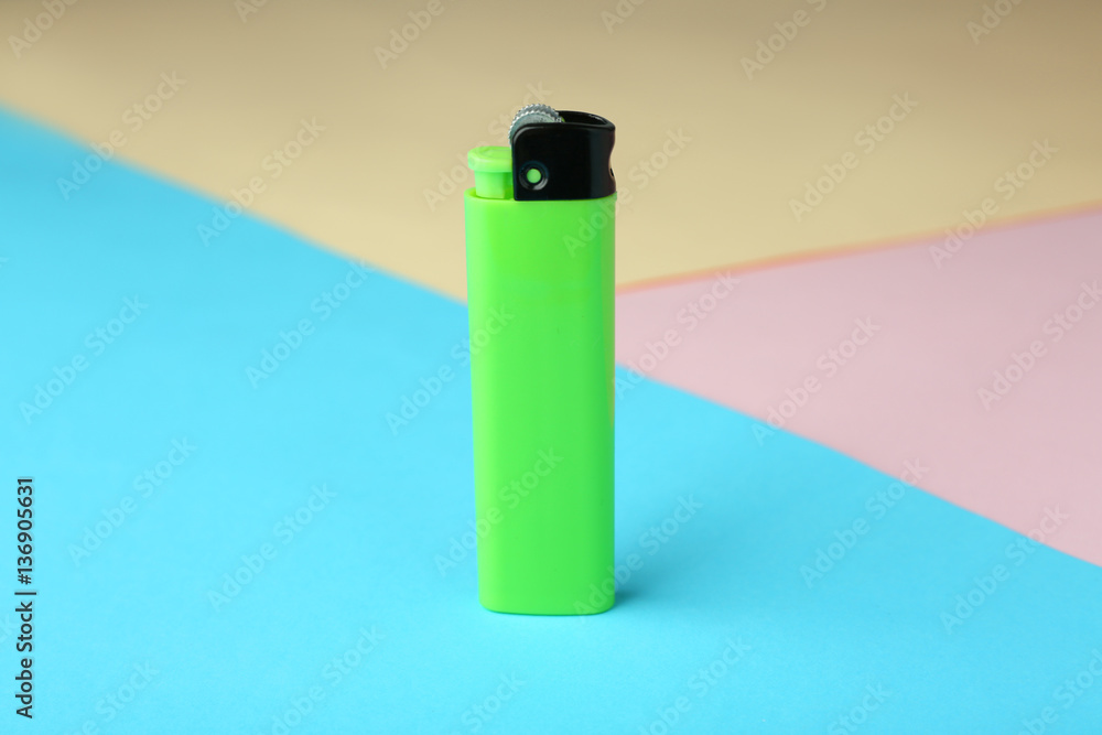 Blank cigarette lighter on color paper background