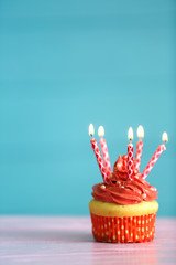 Poster - Birthday cupcake with candles on color background