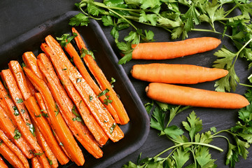 Wall Mural - Roasted carrots with green herbs