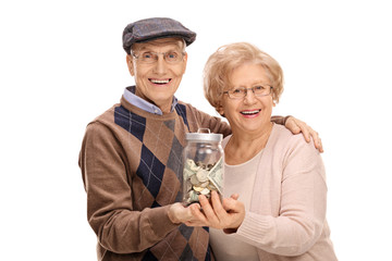 Poster - Joyful seniors holding a jar with money