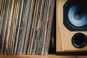 wooden shelf full of old vinyl records and speaker