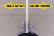 Bad news, good news text arrows on asphalt ground, feet and shoe