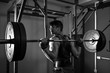 © Alen Ajan - Teenage man doing squats indoor.