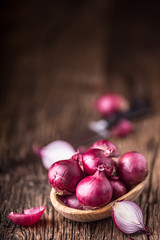 Wall Mural - Onion. Red onions on very old oak wood board. Selective focus.