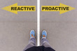 Reactive vs proactive text arrows on asphalt ground, feet and sh