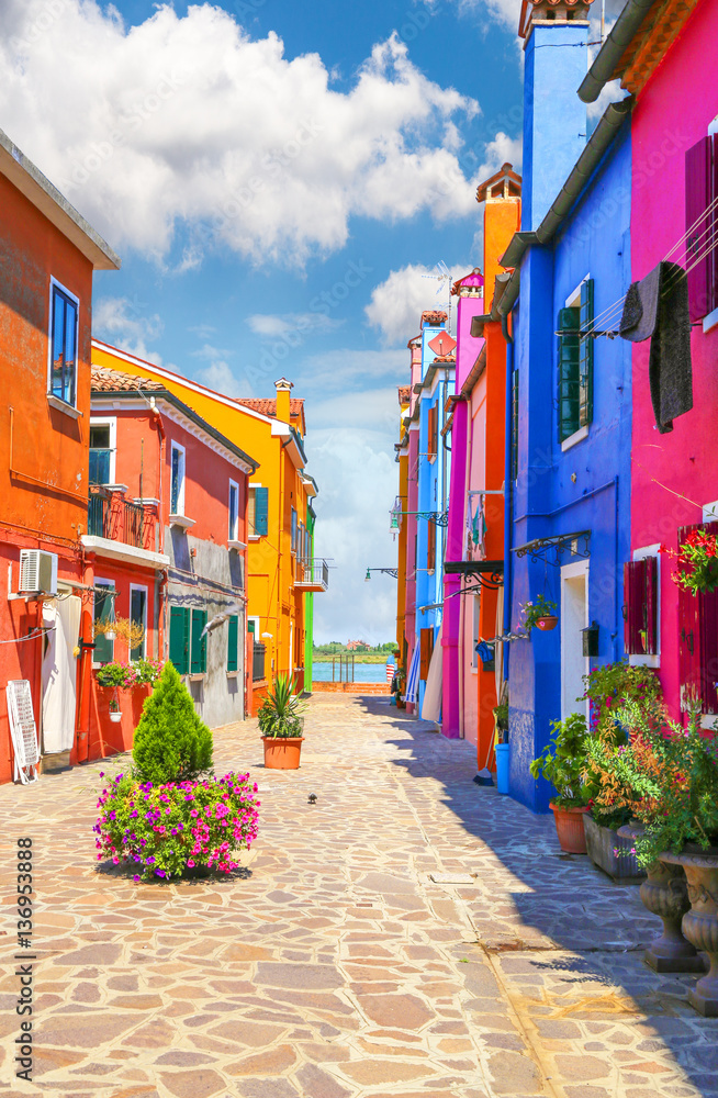 Multicolor houses with fantastic sky in background - obrazy, fototapety, plakaty 