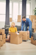 © chika_milan - couple moving in new flat, with boxes with stuff