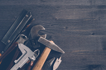 Wall Mural - Old tools on a dark wooden background. Top view