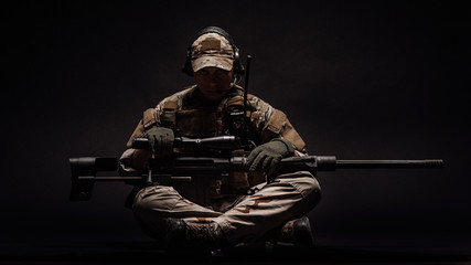 Wall Mural - Portrait soldier or private military contractor holding sniper rifle