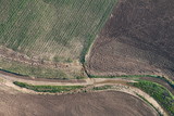 Fototapeta Do pokoju - Aerial view of fields and farmland taken from a hot air balloon