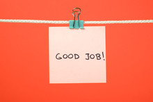 Pink Paper Sheet On The String With Text “Good Job”