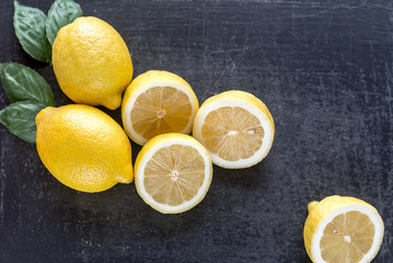 Wall Mural - Fresh lemons on the dark wooden background