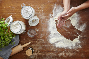 hand dusting of flour in baking scene