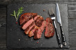 Medium Ribeye steak on black stone plate