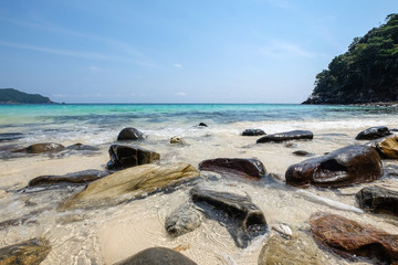 Wall Mural - Landscape of sea sun rock sand beach under blue sky. Summer holi