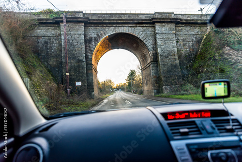 Fotografía Car interior view of traveling below railroad bridge in UK