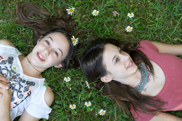 top view of young girls relaxing on the grass