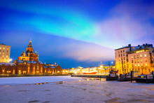 Northern Lights Over The Frozen Old Port In Katajanokka District With Uspenski Orthodox Cathedral In Helsinki, Finland