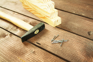 hammer, nails on a wooden background, home repair