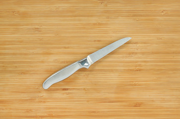 Steel kitchen knives on a wood board with copy Space, Top view