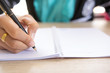 © KPs Photography  - Women hand with pen writing on notebook.