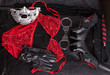 Fetish, stuff for role-playing games and bondage, high heels shoes, leather whip and hand cuffs on a background of black leather