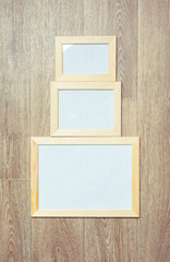 Canvas Print -  photo frames on the wooden wall