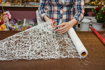 wrapping up a sheaf in paper in flower shop