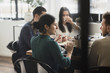 © Maskot - Businesswoman discussing with colleagues during meeting in office