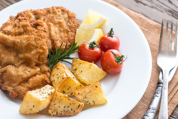 Canvas Print - Portion of schnitzel with garnish