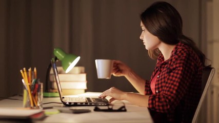 Wall Mural - student or woman typing on laptop at night home