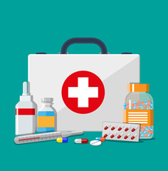 Wall Mural - Medical first aid kit with pills and thermometer