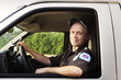 © Cavan Images - Portrait of man driving ambulance