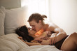 © Cavan Images - Young couple kissing on bed