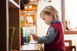 © Cavan Images - Boy (2-3) standing by desk and playing