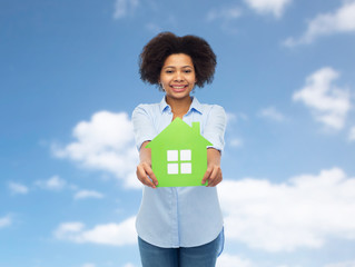 Poster - happy african american woman with green house icon