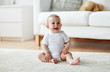 © Syda Productions - happy baby boy or girl sitting on floor at home