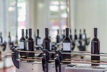 Red Wine Bottling And Sealing Conveyor Line At Winery Factory