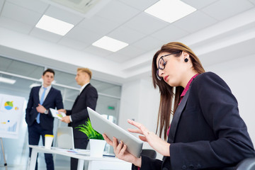 Wall Mural - Businesswoman with glasses working in the office with a tablet his hand.