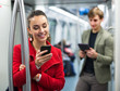 subway passengers with phones