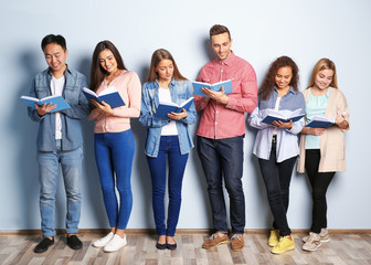 Sticker - Group of people with books standing near light wall