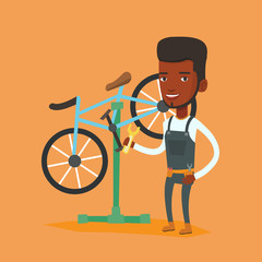 Poster - African bicycle mechanic working in repair shop.