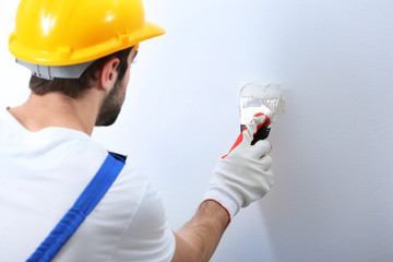 Sticker - Young worker making repair in room