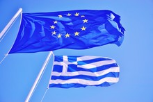A Greek And European Union (EU) Flags Flying Side By Side
