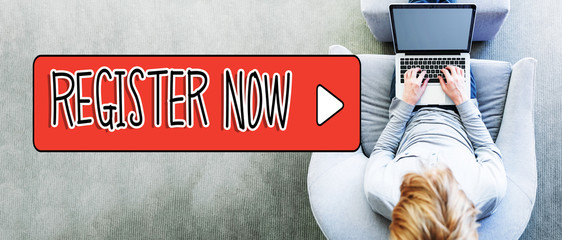 Wall Mural - register now text with man using a laptop