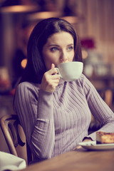 Canvas Print - A shot of a beautiful  woman drinking coffee in a cafe