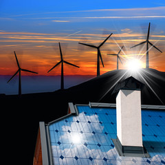 Wall Mural - Wind and Solar Energy Concept - House roof with a solar panel and wind turbines