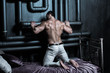 © zoya - Young healthy handsome attractive sexy bodybuilder poses on a purple bed demonstrating muscular back