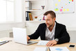 © Prostock-studio - Young businessman working with laptop in modern white office